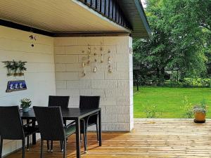 a patio with a table and chairs on a deck at 5 person holiday home in Vinderup in Vinderup