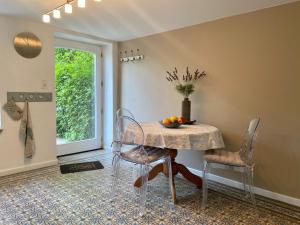 a dining room with a table and two chairs at Suave Holiday Home in Stavelot with Infrared Sauna in Stavelot