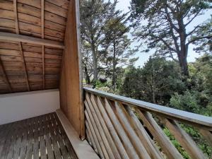 a balcony of a house with trees in the background at Villa Carnac, 3 pièces, 6 personnes - FR-1-477-207 in Carnac