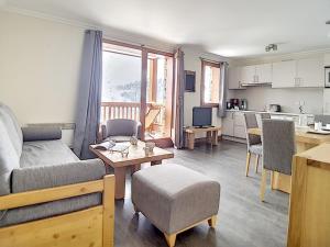 a living room with a couch and a table at Appartement rénové proche pistes avec Sauna, Hammam et WIFI - FR-1-344-788 in Levassaix +7 photos