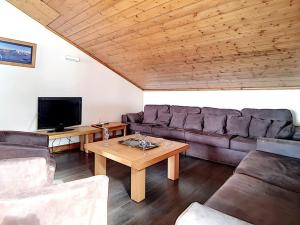 a living room with a couch and a tv at Appartement spacieux et rénové, 10 personnes, 4 Flocons OR, sauna et hammam - FR-1-344-786 in Levassaix