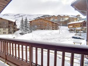 a balcony with a view of a snow covered city at Appartement spacieux et rénové, 10 personnes, 4 Flocons OR, sauna et hammam - FR-1-344-786 in Levassaix
