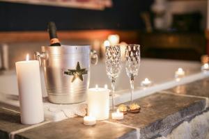 a table with candles and champagne glasses and a bucket at Gold Mountain Manor in Big Bear City