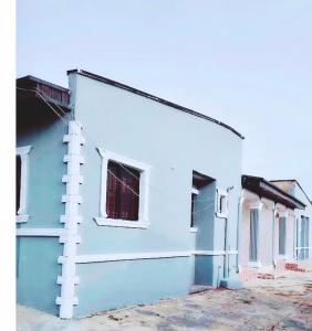 a blue and white building with white windows at 8 bedroom holiday home with great ambiance in Ofatedo