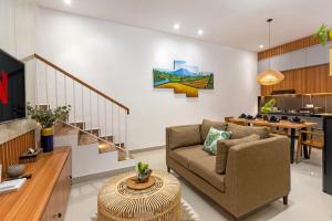a living room with a couch and a table at Vin Villa Canggu 3 BR with private pool in Canggu