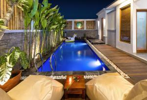 a swimming pool in the middle of a house at Vin Villa Canggu 3 BR with private pool in Canggu