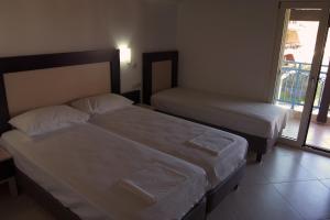 Postel nebo postele na pokoji v ubytování Hotel Dellis