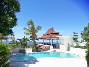 a villa with a swimming pool and a gazebo at Soul Lodge Villa Lovina in Banjar