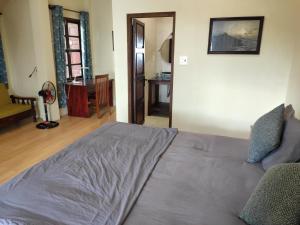 a bedroom with a bed and a living room at Haven Vietnam in Quy Nhon