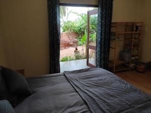 a bedroom with a bed and a door to a patio at Haven Vietnam in Quy Nhon