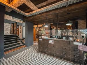 a large kitchen with a counter and a staircase at PX122 DBEST HOTEL in Nan