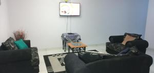 a living room with two couches and a table at LILIAN Self Catering Accommodation in Swakopmund
