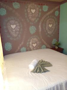 a bedroom with a bed with hearts on the wall at Casa el Jardin in Fortuna