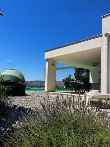 a house with a boat sitting on the beach at Villa Mona ,heated swimming pool in Mostar