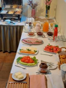 a table with many plates of food on it at Hotel Santa in Sigulda