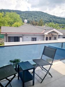 a pair of chairs and a table on a balcony at Ozilvillas in Sapanca