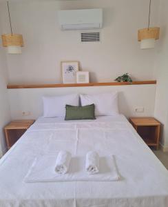 a white bed with two pairs of slippers on it at Ozilvillas in Sapanca +61 photos