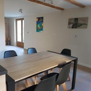 una sala conferenze con tavolo e sedie in legno di Appartement entre lac et montagnes a Saint-Paul-en-Chablais