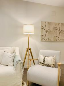 a living room with a couch and a lamp and a chair at Sea view luxury new apartment Marbella Port in Marbella