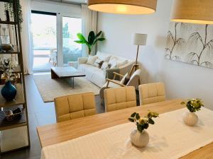 a living room with a table and a couch at Sea view luxury new apartment Marbella Port in Marbella