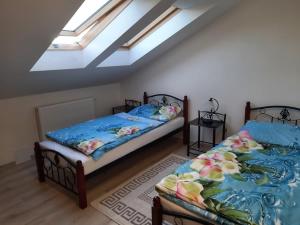 a bedroom with two beds and a skylight at Privat Magnolia in Mošovce