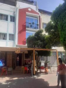 a woman walking in front of a building at Christian Place in Praia