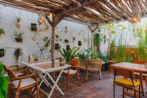 a patio with a table and chairs and plants at ISLA INDAH RETREAT boutique hotel in Nusa Lembongan