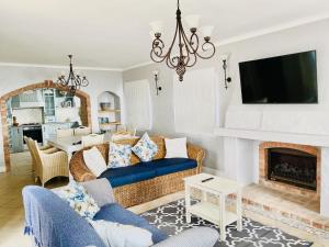 a living room with a couch and a fireplace at Casa Balena - Gansbaai seafront accommodation, back-up power in Gansbaai