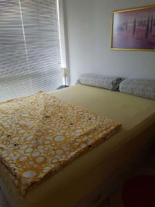 a bedroom with a bed with a blanket on it at Ravda Sun Sea Ressort 2 in Ravda +10 photos