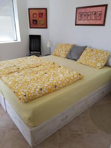 a large bed with a yellow blanket on it at Ravda Sun Sea Ressort 2 in Ravda