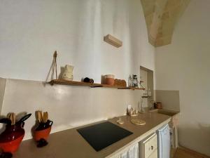 a kitchen with a sink and a counter top at La Corte dei Colori in Spongano