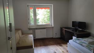 a living room with a couch and a window at Brilliant Home Messe in Nuremberg