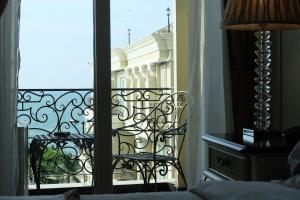 a room with a balcony with a view of a building at LK The Empress in Pattaya Central
