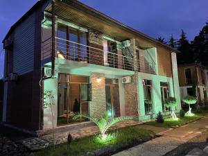 a house with lights on the side of it at Cottages Ureki in Ureki