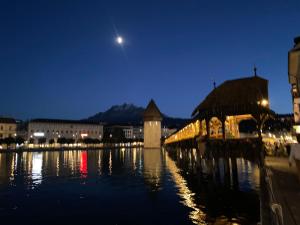 a bridge over the water in a city at night at Apartment auf dem Bauernhof in Lucerne