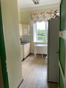 a kitchen with a sink and a window in a room at Endla Hostel in Haapsalu