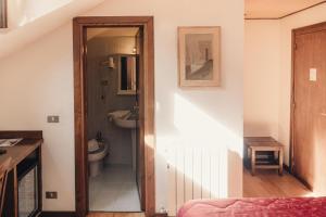 a bathroom with a toilet and a sink at Albergo il Plistia in Pescasseroli