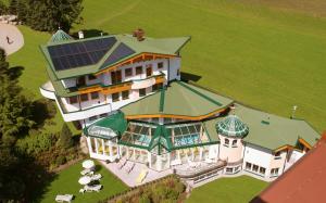 an aerial view of a large house with a solar roof at Hotel Neue Post in Hippach