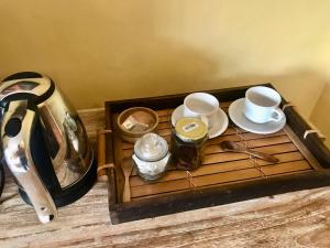 a tray with two cups and plates on a table at Ubud home stay 2 in Payangan
