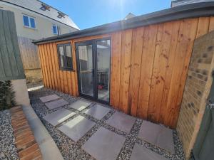 a house with a wooden fence and a patio at The Little Hideaway in Truro