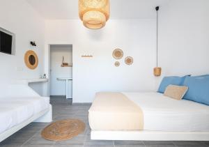 a white room with a bed and a couch at Dorkas Luxury Rooms&Apartments in Livadakia