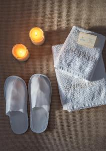 a pair of silver shoes and a pair of candles at Dorkas Luxury Rooms&Apartments in Livadakia