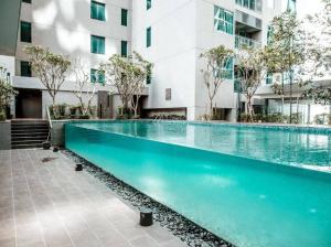 a swimming pool in front of a building at Summer Suites Apartment @KLCC by Sarah's Lodge in Kuala Lumpur
