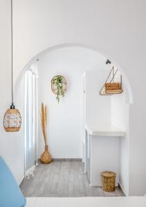 a room with white walls and a hallway with a sink at Dorkas Luxury Rooms&Apartments in Livadakia