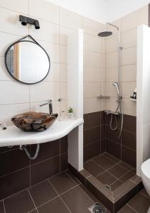 a bathroom with a sink and a shower at Dorkas Luxury Rooms&Apartments in Livadakia