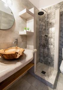 a bathroom with a wooden sink and a shower at Dorkas Luxury Rooms&Apartments in Livadakia