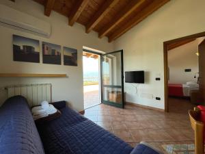 a living room with a blue couch and a television at Residence Bellavista in Manerba del Garda