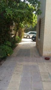 a brick walkway with a car parked next to a building at Villa Dr. Atef Darwish in Alexandria