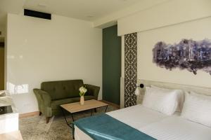 A bed or beds in a room at Rooftop Apart-Hotel