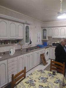 a man sitting at a table in a kitchen at Villa Dr. Atef Darwish in Alexandria